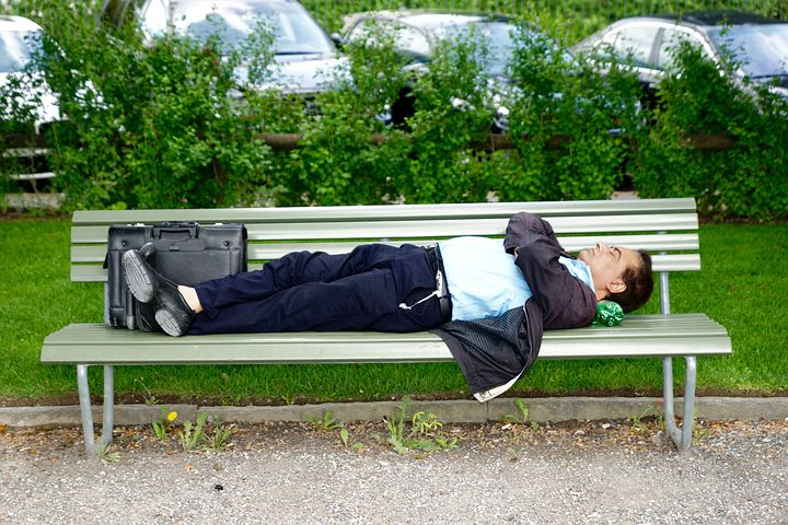 Man sleeping on park bench